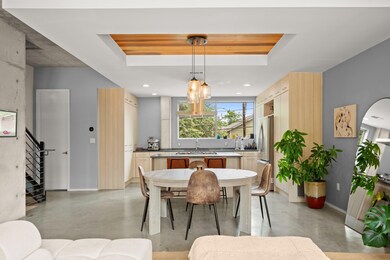 Dining room featuring concrete floors, a raised c