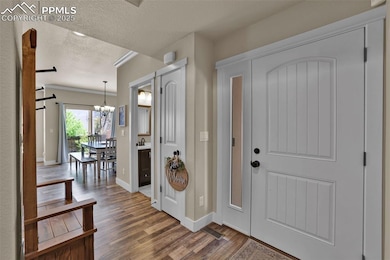Entryway with a textured ceiling, a barn door, woo