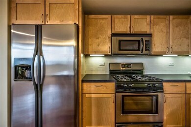 stainless steel appliances with subway tile as the