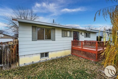 Front view with deck, shutters and large willow tree.