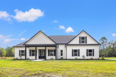 Modern inspired farmhouse featuring a front yard a