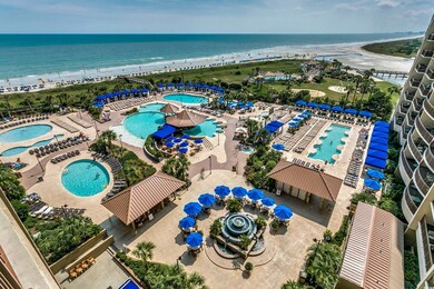Drone / aerial view of a pool and a nearby body of water