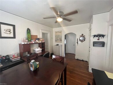 Dining room featuring dark hardwood flooring, ceiling fan, and radiator heating unit