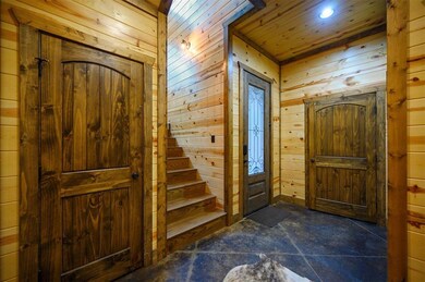 Entryway featuring wooden walls