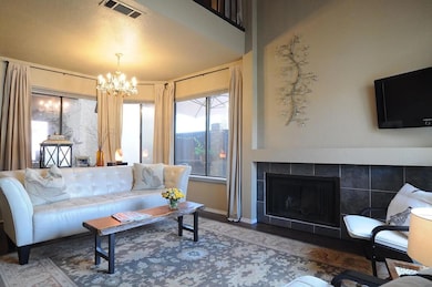 Living area featuring a chandelier, visible vents,