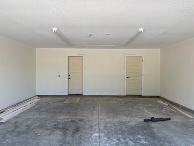 Garage featuring baseboards