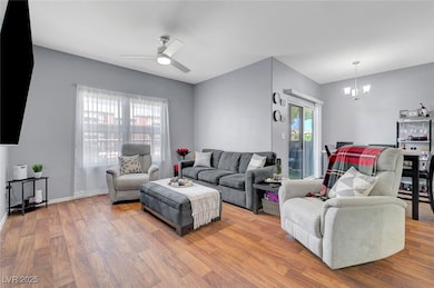 Living area with a chandelier, wood finished floor