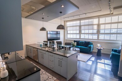 Kitchen with decorative light fixtures, sink, rail
