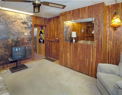 Living Room. The living room holds a couch and 2 c