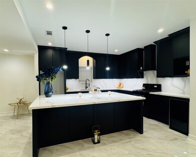 Modern kitchen with sleek black cabinetry, white c