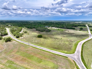 Overview of rural landscape featuring a heavily wooded area