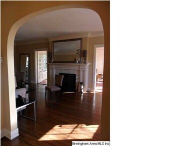 Entry hall with graceful arches to living room