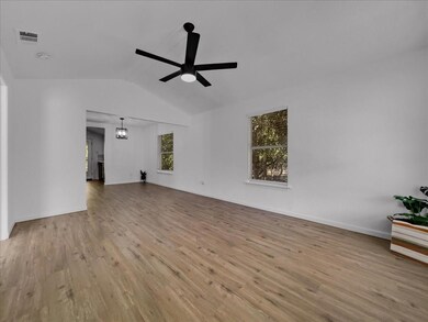 Unfurnished living room with ceiling fan, vaulted 