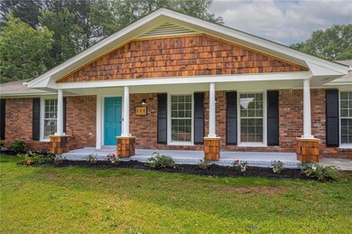 View of front of house with a porch, brick siding,