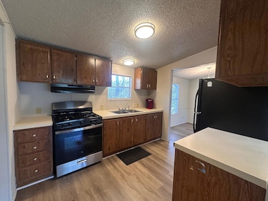 Kitchen featuring stainless steel gas range, unde