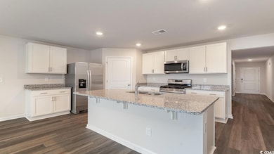 Kitchen with stainless steel appliances, white cab