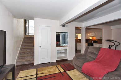 The entry door is at the top of the stairs.  The l