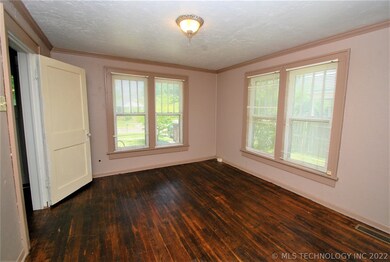 Front Bedroom offers the original hardwoods, windo
