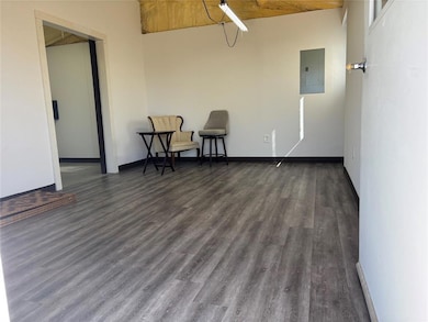 Living area with electric panel, wood finished fl