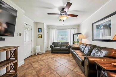 Cozy living area with neutral tones, crown molding