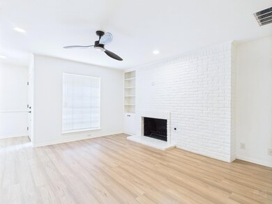Unfurnished living room with a ceiling fan, light