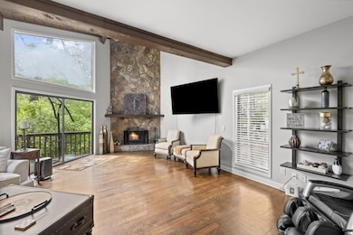 Living room with vaulted wood ceiling.