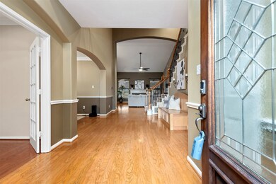 Attractive entry with high ceilings and wood floors front to back.