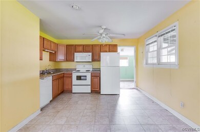 Kitchen with white appliances, brown cabinets, cei