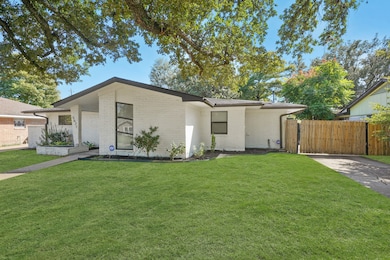 You will Enjoy the Electronic Driveway Gate which provides Privacy, Security, and a Fenced Area along the Driveway where Children can ride their bikes and Tricycles as well as Pets being secured behind the Gate.  The Landscaped Front Yard includes a Built-in Brick Planter Box and a Majestic Oak Tree (Notice the Limbs & Pretty Leaves towards the Upper Part of the Photo) - Nice!