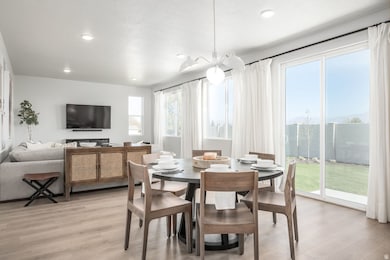 A bright, airy space where the kitchen and dining room come together in perfect harmony. *model