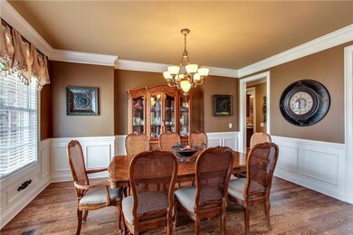 Stunning separate dining room with wainscoting and hardwood flooring.