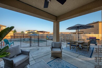 Patio and pool with water feature.
