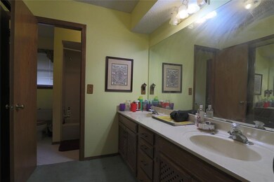 Bathroom with toilet, tile patterned floors, and d
