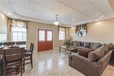 Living area with light tile patterned flooring, re