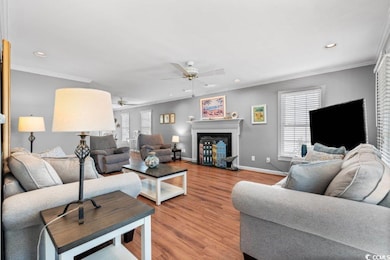 Living room with ceiling fan, wood-type flooring, 