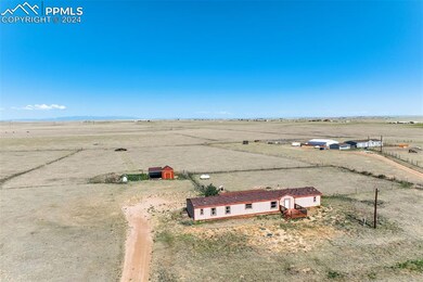Birds eye view of property featuring a rural view