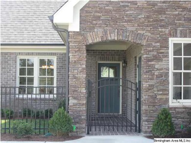 Covered brick walkway leading to front entrance