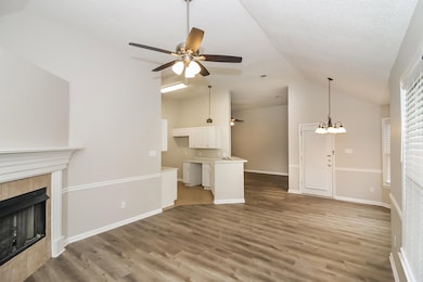 Unfurnished living room featuring a fireplace, lig