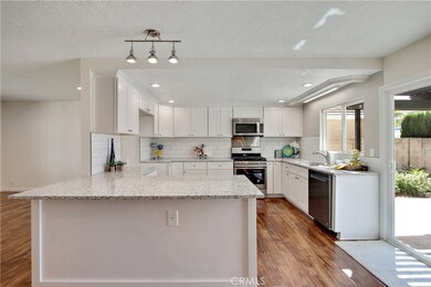 Sleek granite counter tops and full subway tile back splash