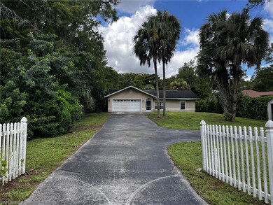 Ranch-style home featuring a front lawn and a gara