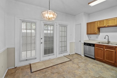 Kitchen with a sink, pendant lighting, a chandelie