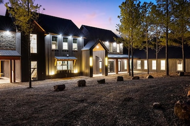 View of front of property with board and batten siding, metal roof, and a standing seam roof