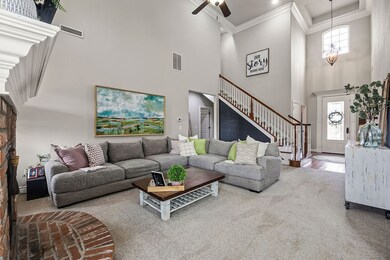 Tall ceilings and crown molding in the living room and front entrance with lots of natural light flowing in.