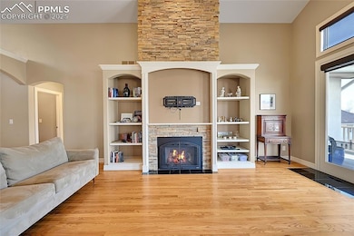 Living room featuring baseboards, built in feature