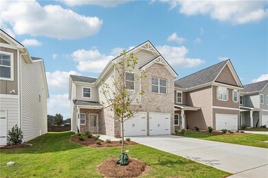 View of front facade with driveway, brick siding, 