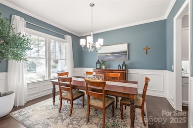 The formal dining room shines with timeless wainscoting and seamless access to the kitchen through the butler’s pantry—perfect for effortless entertaining.