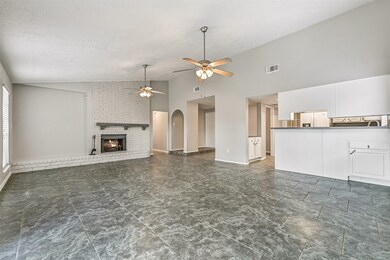 Family room with wood fireplace ~ Open concept ~ Extensive tile flooring