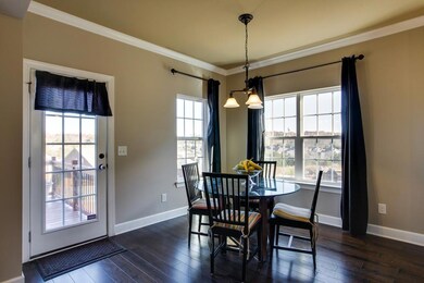 The Breakfast Room is a great space to read the morning paper and have a cup of coffee. Notice the elegant oil-rubbed bronze light fixture and the deck access.