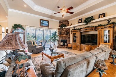 Great Room with stone gas fireplace and view to th