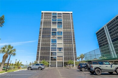 View of building exterior with uncovered parking